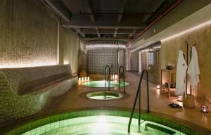 a room with a swimming pool in a building at Wellcomm Spa & Hotel in Medellín