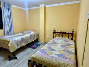 a bedroom with two beds in a room at DEPA CENTRICO CARAZ in Caraz