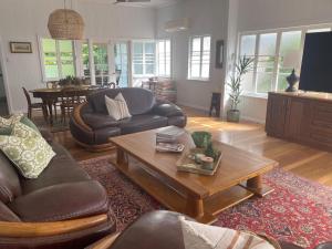 a living room with a couch and a coffee table at The Grand Queenslander On Turner in Aitkenvale