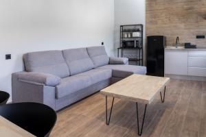 a living room with a couch and a table at Complejo Mirador del Castillo in Alcalá del Júcar