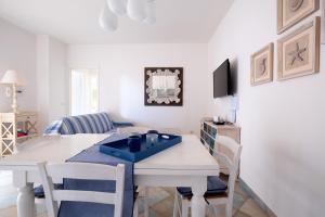 a kitchen and dining room with a table and chairs at Orosei Home Holidays - Sa Vadde in Cala Liberotto