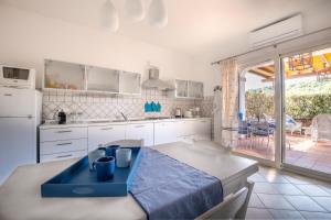 a kitchen with a table with a blue tray on it at Orosei Home Holidays - Sa Vadde in Cala Liberotto