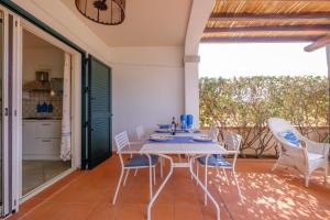 a dining room with a table and chairs on a patio at Orosei Home Holidays - Sa Vadde in Cala Liberotto +19 photos
