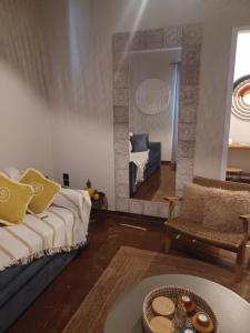 a living room with a couch and a mirror at Villa Chrisalena in Nafplio