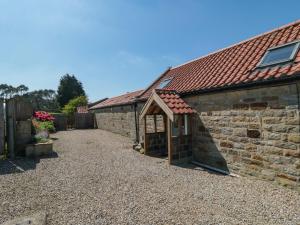 an old stone building with a small door on it at Barn Cottage in Whitby
