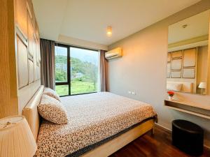 a bedroom with a bed and a large window at Comfy 1 Bedroom Condo in Surin (Seaview Rooftop Pool & Gym) in Phuket Town +25 photos