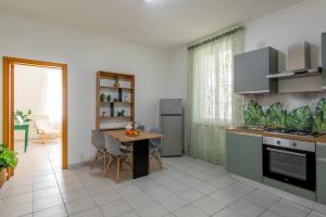 a kitchen with a table and a dining room at Casa Nonnogià in Foligno