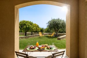 a table with food on it in a garden at Fiore di Vendicari B&B - Sicilian Charme, Lemon Grove and Sea in Noto