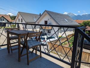 a table and a chair on a balcony at Domen's cozy rentals in Kranj