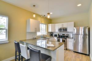 a kitchen with white cabinets and a stainless steel refrigerator at Downtown Buena Vista Condo Walk to River and Cafes! in Buena Vista