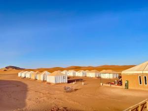 an overhead view of a desert with rows of tents at Chegaga Starlight Camp - Mhamid Desert Haven in Mhamid