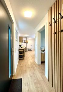 a hallway with a room with a desk and a kitchen at Tiny House Village Löffingen in Löffingen