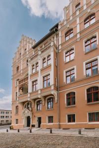 a large building in front of a building at Art Apartment in Toruń