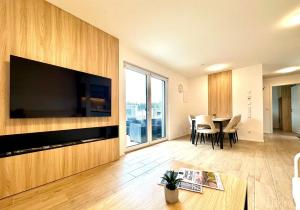 a living room with a large television and a table at Tiny House Village Löffingen in Löffingen