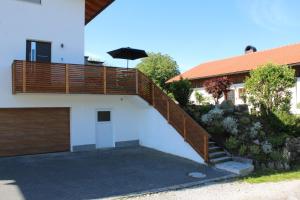 a house with a wooden ramp leading up to a garage at Ferienwohnung an der Jodquelle in Bad Endorf