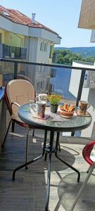a table with a tray of food on a balcony at Azzurro Apartman Srebrno Jezero in Veliko Gradište +8 photos