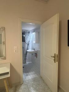 a bathroom with a sink and a white door at Sunny house in Kremasti +48 photos