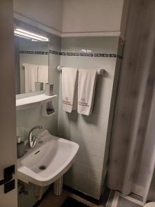 a bathroom with a sink and a mirror and towels at Villa Chrisalena in Nafplio +31 photos