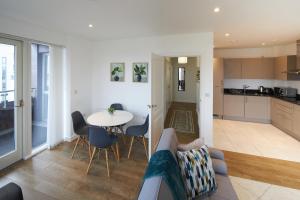 a living room with a couch and a table at Canary Haven- Luxury 2 bedroom 2 bathroom Apartment in London