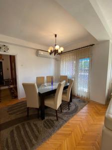 a dining room with a table and chairs at Dena Apartment in Kumanovo