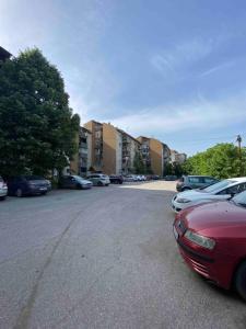 a parking lot with a lot of parked cars at Dena Apartment in Kumanovo