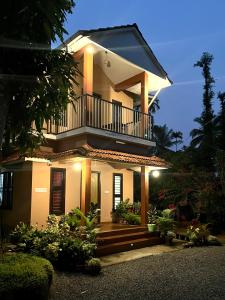a large house with a balcony on top of it at Sahyadri Homestay wayanad in Kalpetta