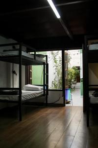 a room with three bunk beds and a wooden floor at Reserva 69 Hostel in Sao Paulo +53 photos