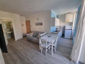 a kitchen and a living room with a table and chairs at Residenza Serenella - Dependance in Diano Marina