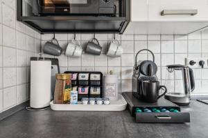 a kitchen with a counter with a coffee pot on a stove at P&K Apartment in Dinslaken
