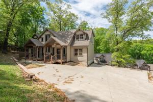 a house with a large driveway in front of it at 3BR Walk-In Near Silver Dollar City - Game Room - Pool - FREE TICKETS INCLUDED - RR93A in Branson