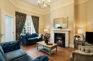 a living room with a couch and a fireplace at The K Club in Straffan