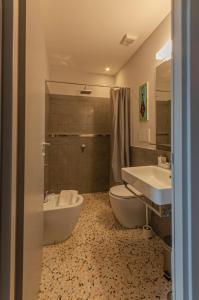 a bathroom with a tub and a toilet and a sink at La Bruna in Porto Santo Stefano +44 photos