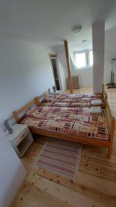 a bedroom with a large bed in a room at Guest house Griva Plitvice in Korenica