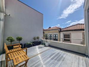 an empty patio with two chairs on a balcony at Casa do Trigo - with garage in the city center in Viana do Castelo