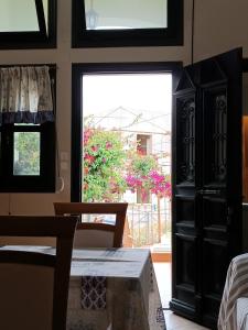 a room with a bedroom with a window and a dresser at Seaside Apartment 2 in Emborios Kalymnos
