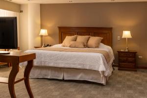 a bedroom with a bed and a flat screen tv at Gran Hotel Toloma in Cochabamba +79 photos