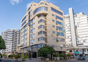 a tall white building on a city street at Gran Hotel Toloma in Cochabamba