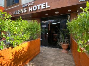 an entrance to a marias hotel with potted plants at iNALENS AİRPORT HOTEL in Arnavutköy