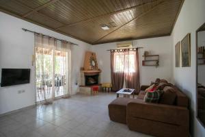 a living room with a couch and a fireplace at Tinas Dreams By The Sea in Afantou