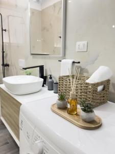 a bathroom with a sink and a washing machine at Boulevard Apartaments - Vlora in Vlorë +25 photos