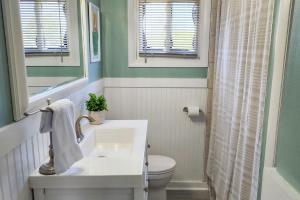 a bathroom with a sink and a toilet at Dockside Daydreamin' in Ocean City +28 photos