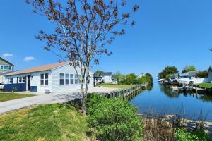 a house with a dock next to a river at Dockside Daydreamin' in Ocean City