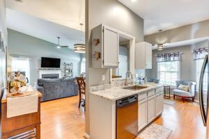a kitchen and living room with a sink and a couch at Wilmington Family Home 6 Mi to Wrightsville Beach in Wilmington