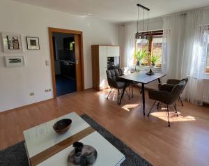 a living room with a dining room table and chairs at Ferienwohnung Am Kiessee Birkwitz in Pirna