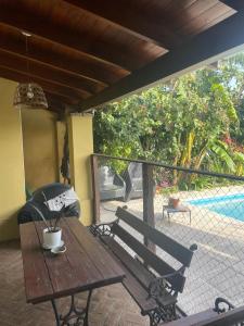a wooden table and a bench on a patio at El Descanso Casa de retiro in Tandil