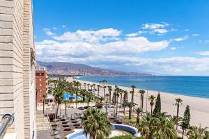 a view of the beach from the balcony of a resort at Vista del Mar Residencial in Roquetas de Mar
