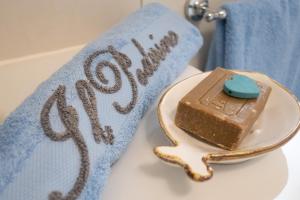 a piece of chocolate cake on a plate next to a towel at Villa il Poderino in Marina di Campo