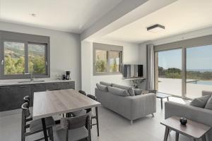 a living room with a table and a couch at Brand New Kefalonia Stone Villas - Villa Trapezaki Tranquility in Trapezaki