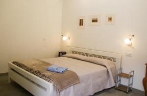 a bedroom with a bed with a blanket on it at Villa il Poderino in Marina di Campo