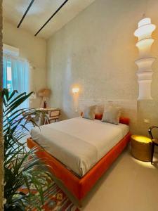 a bedroom with a bed and a plant in it at FUTURA ROOM&RELAX in Termoli